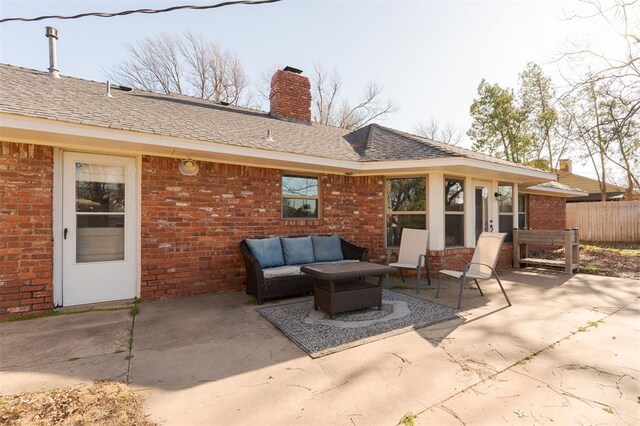 view of patio with outdoor lounge area and fence