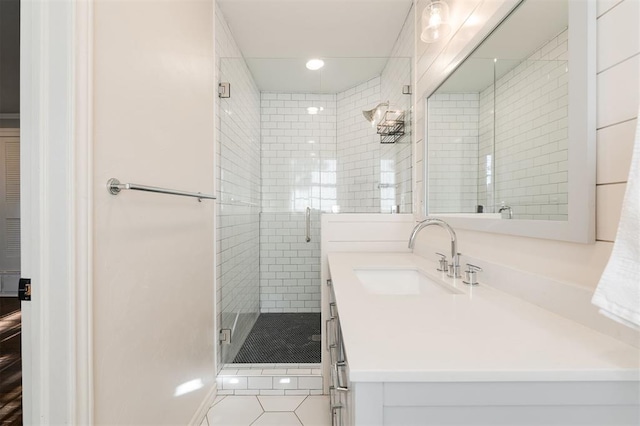 full bathroom with tile patterned floors, vanity, and a shower stall