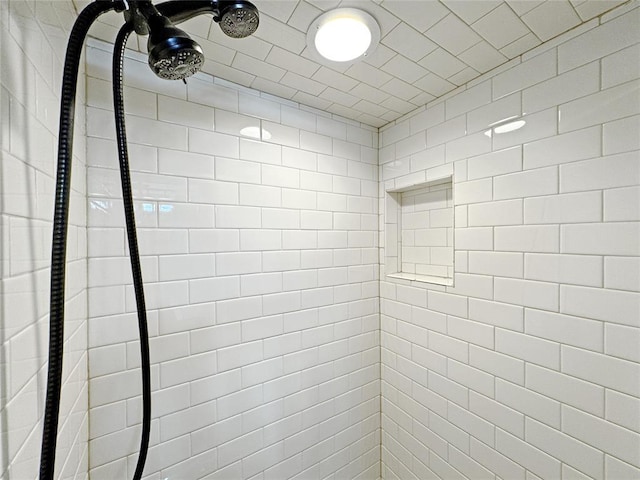 interior details featuring tiled shower