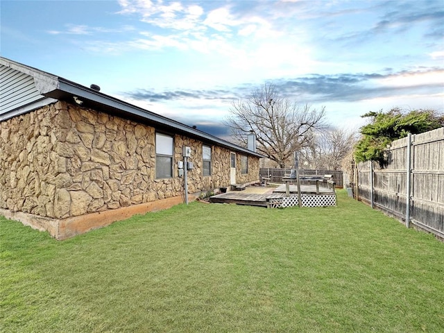 view of yard with a wooden deck and fence