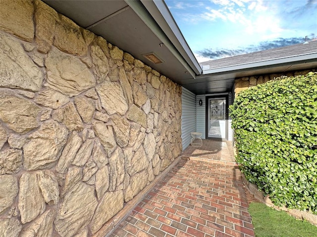 doorway to property with stone siding