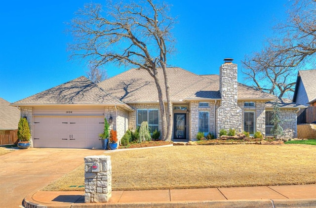 view of front of property featuring concrete driveway, a front lawn, a garage, and a chimney