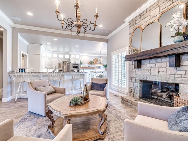 living area with a stone fireplace, an inviting chandelier, light wood-style flooring, and crown molding