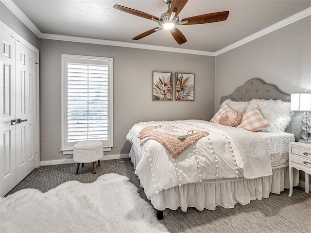 carpeted bedroom featuring a closet, ceiling fan, crown molding, and baseboards