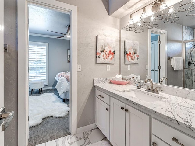 bathroom featuring marble finish floor, connected bathroom, ceiling fan, vanity, and a textured wall