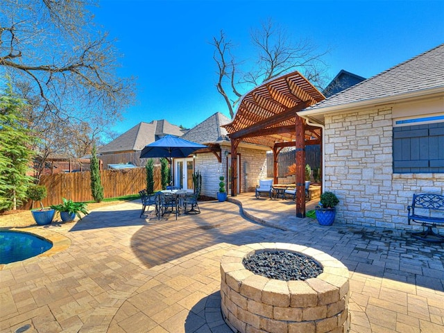 view of patio / terrace featuring outdoor dining area, a fire pit, a pergola, and fence