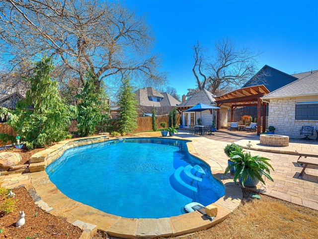 outdoor pool featuring a gazebo, a fenced backyard, a fire pit, and a patio