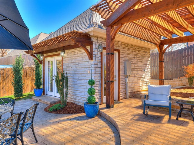 view of patio / terrace featuring fence, french doors, and a pergola