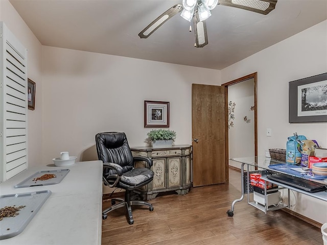 home office featuring wood finished floors and a ceiling fan