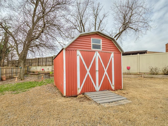 view of outdoor structure with an outbuilding and a fenced backyard