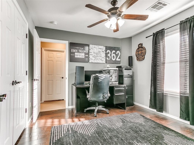 home office with visible vents, baseboards, wood finished floors, and a ceiling fan