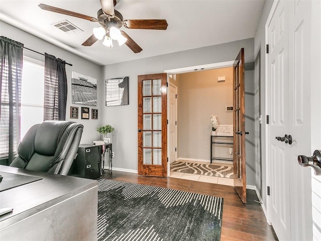 home office featuring ceiling fan, wood finished floors, visible vents, and baseboards