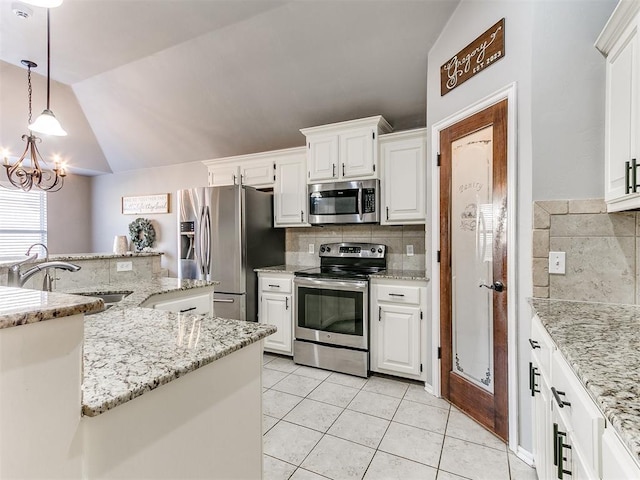 kitchen with light tile patterned floors, white cabinetry, stainless steel appliances, and vaulted ceiling