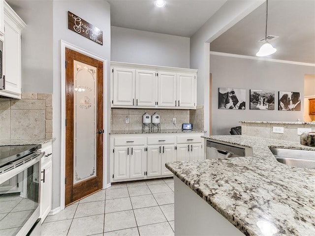 kitchen with visible vents, light stone counters, hanging light fixtures, white cabinets, and stainless steel appliances