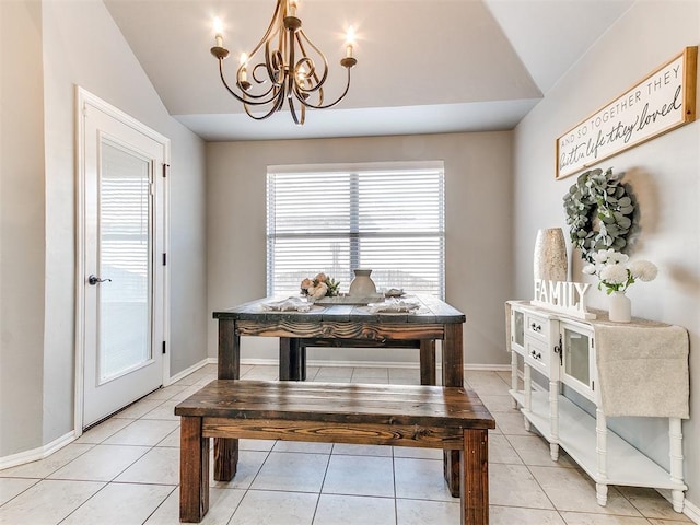 dining space featuring baseboards, a chandelier, light tile patterned flooring, and vaulted ceiling