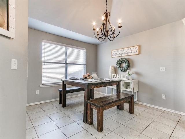 dining area featuring a chandelier, baseboards, and light tile patterned flooring