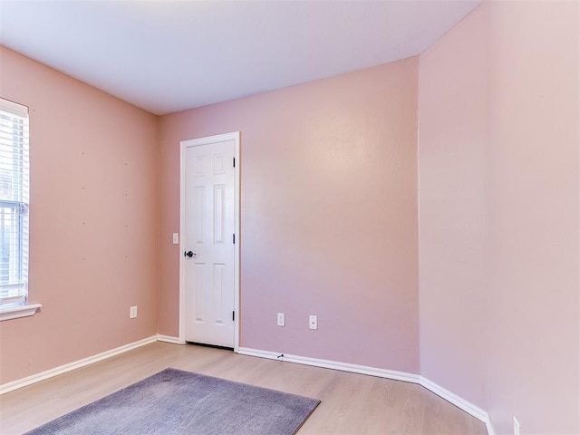 unfurnished room with wood finished floors and baseboards