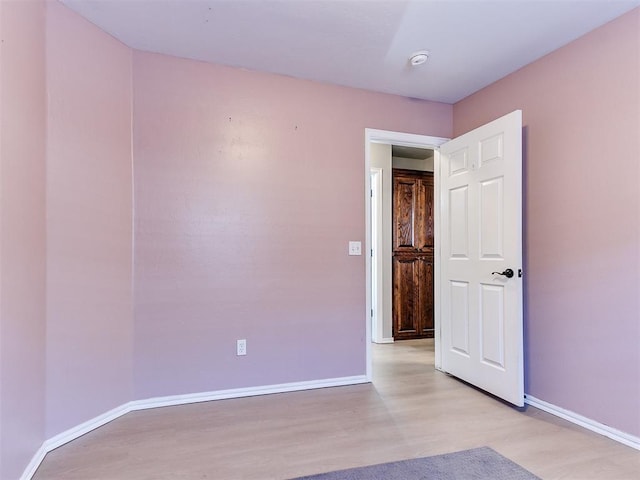 unfurnished room featuring light wood-style flooring and baseboards