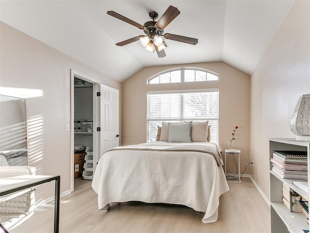 bedroom with baseboards, lofted ceiling, a ceiling fan, and light wood finished floors