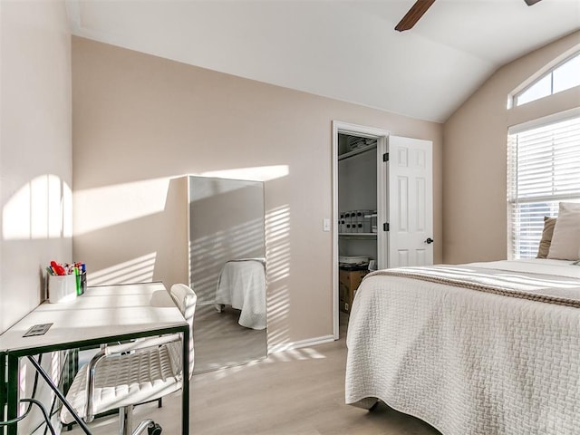 bedroom featuring a ceiling fan, vaulted ceiling, wood finished floors, and baseboards