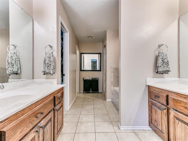 full bathroom with visible vents, a garden tub, tile patterned flooring, baseboards, and vanity