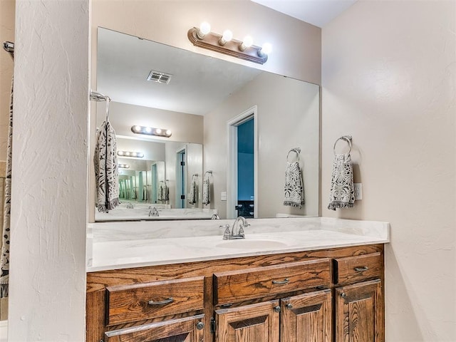 bathroom with vanity and visible vents