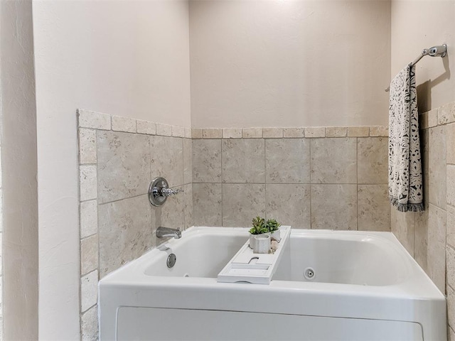 bathroom featuring a tub with jets