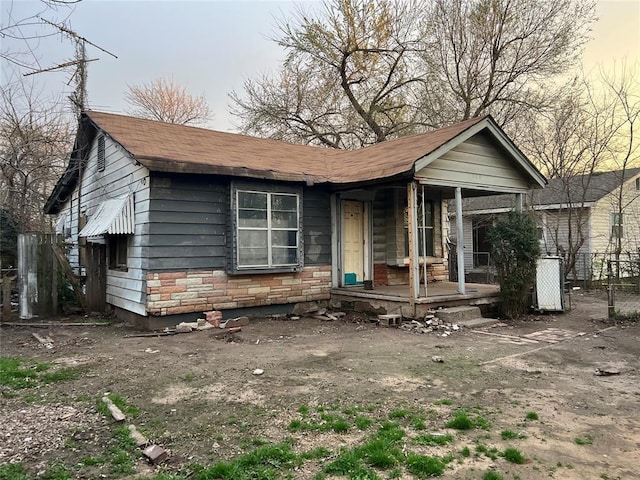 view of front of house with a porch and fence