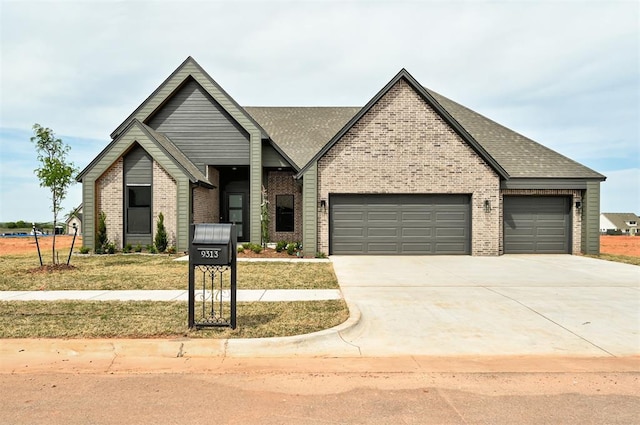 9313 NW 146th St, Yukon, OK 73099 - view of front facade featuring an attached garage, a front lawn, driveway, and brick siding