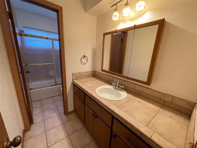 full bath with vanity, tile patterned flooring, and enclosed tub / shower combo