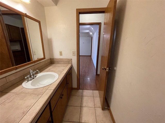 bathroom with tile patterned flooring, vanity, and baseboards