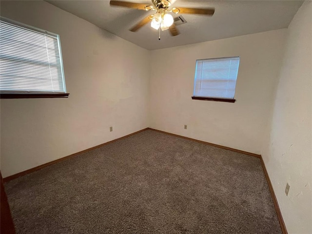 spare room featuring visible vents, a ceiling fan, baseboards, and carpet floors