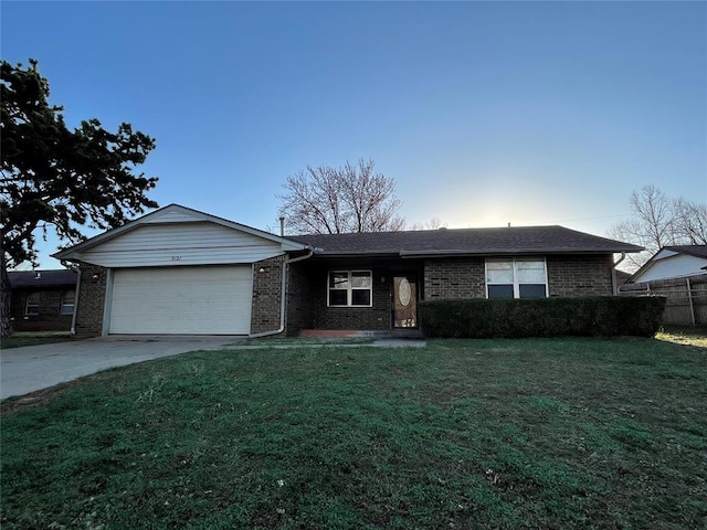 ranch-style home featuring a front yard, fence, driveway, an attached garage, and brick siding