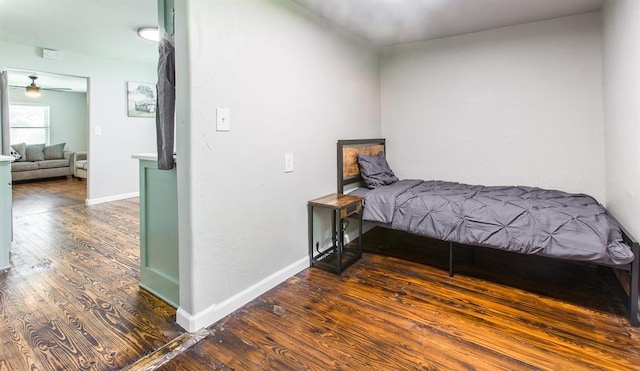 bedroom featuring baseboards and hardwood / wood-style flooring