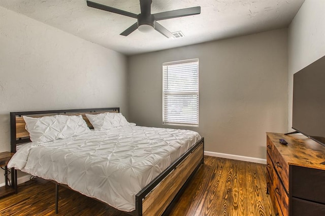 bedroom with visible vents, ceiling fan, baseboards, and wood finished floors