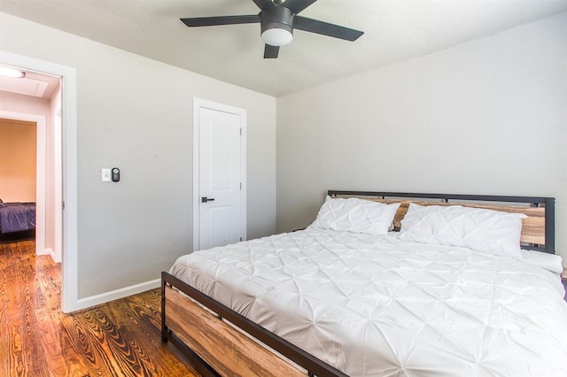 bedroom with a ceiling fan, baseboards, and wood finished floors