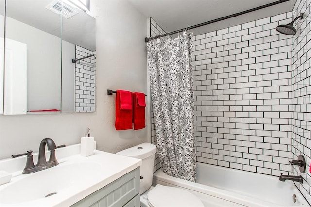 bathroom featuring visible vents, toilet, vanity, and shower / bath combination with curtain