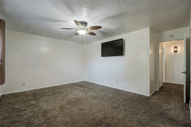 carpeted spare room with baseboards, a textured ceiling, ceiling fan, and a textured wall