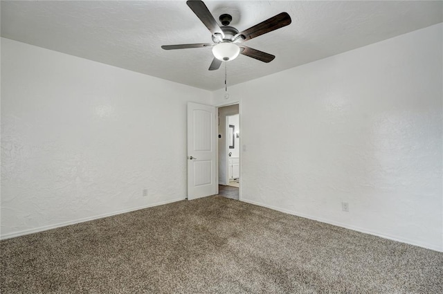 empty room featuring baseboards, carpet floors, ceiling fan, a textured ceiling, and a textured wall