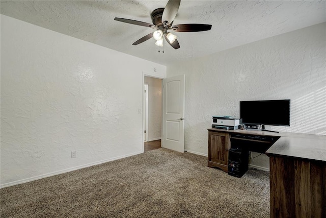 carpeted office space with baseboards, a textured ceiling, a ceiling fan, and a textured wall