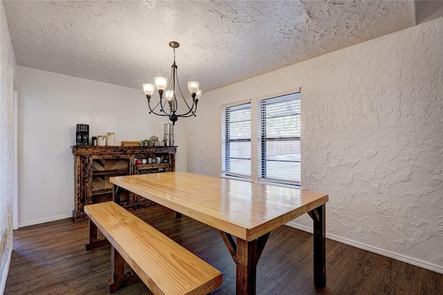 dining area featuring baseboards, dark wood-style flooring, a textured ceiling, a notable chandelier, and a textured wall