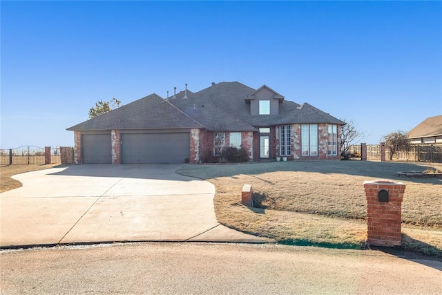 view of front facade featuring brick siding, concrete driveway, fence, and a garage