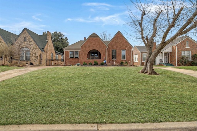 view of front of home with brick siding and a front yard