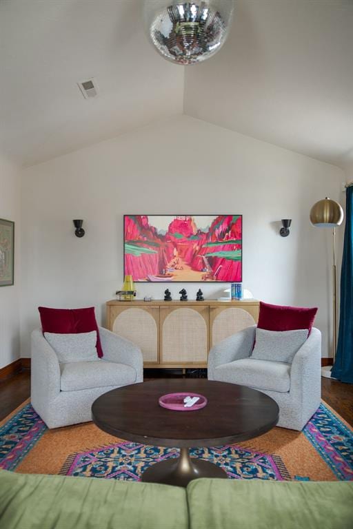 living room featuring vaulted ceiling, baseboards, and visible vents