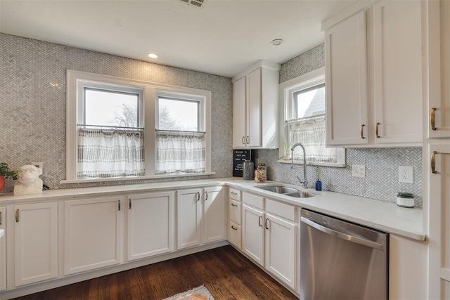 kitchen featuring dishwasher, light countertops, dark wood-style floors, white cabinetry, and a sink