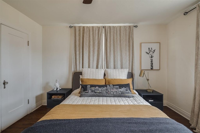 bedroom with baseboards and wood finished floors