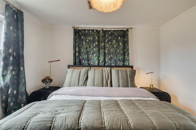 bedroom featuring visible vents and ornamental molding