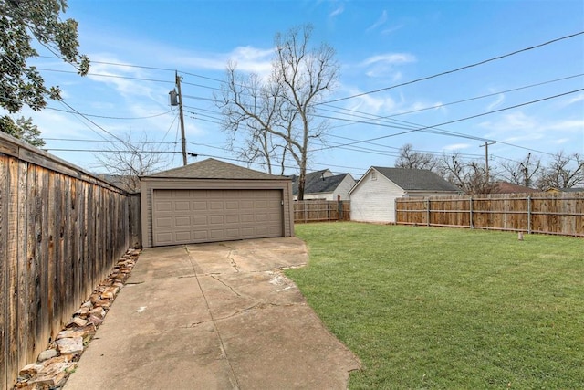 view of yard with an outbuilding, a fenced backyard, and a garage