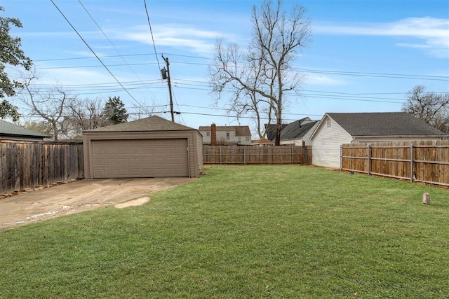 view of yard with an outdoor structure, a fenced backyard, and a detached garage