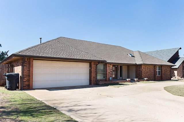 ranch-style house with a garage, brick siding, driveway, and a shingled roof